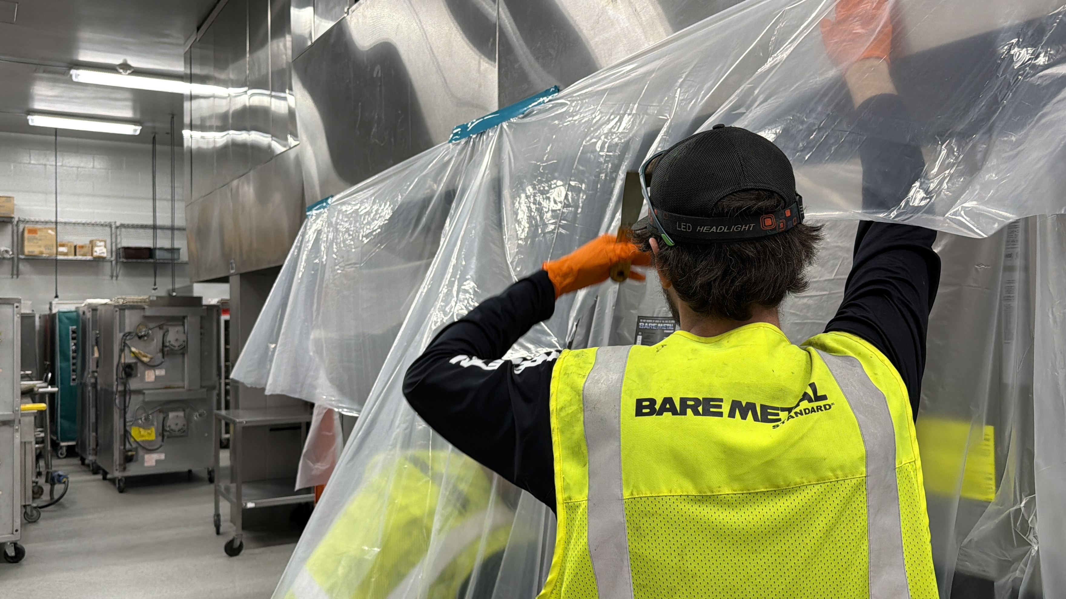 bare metal standard technician cleaning commercial kitchen exhaust hood