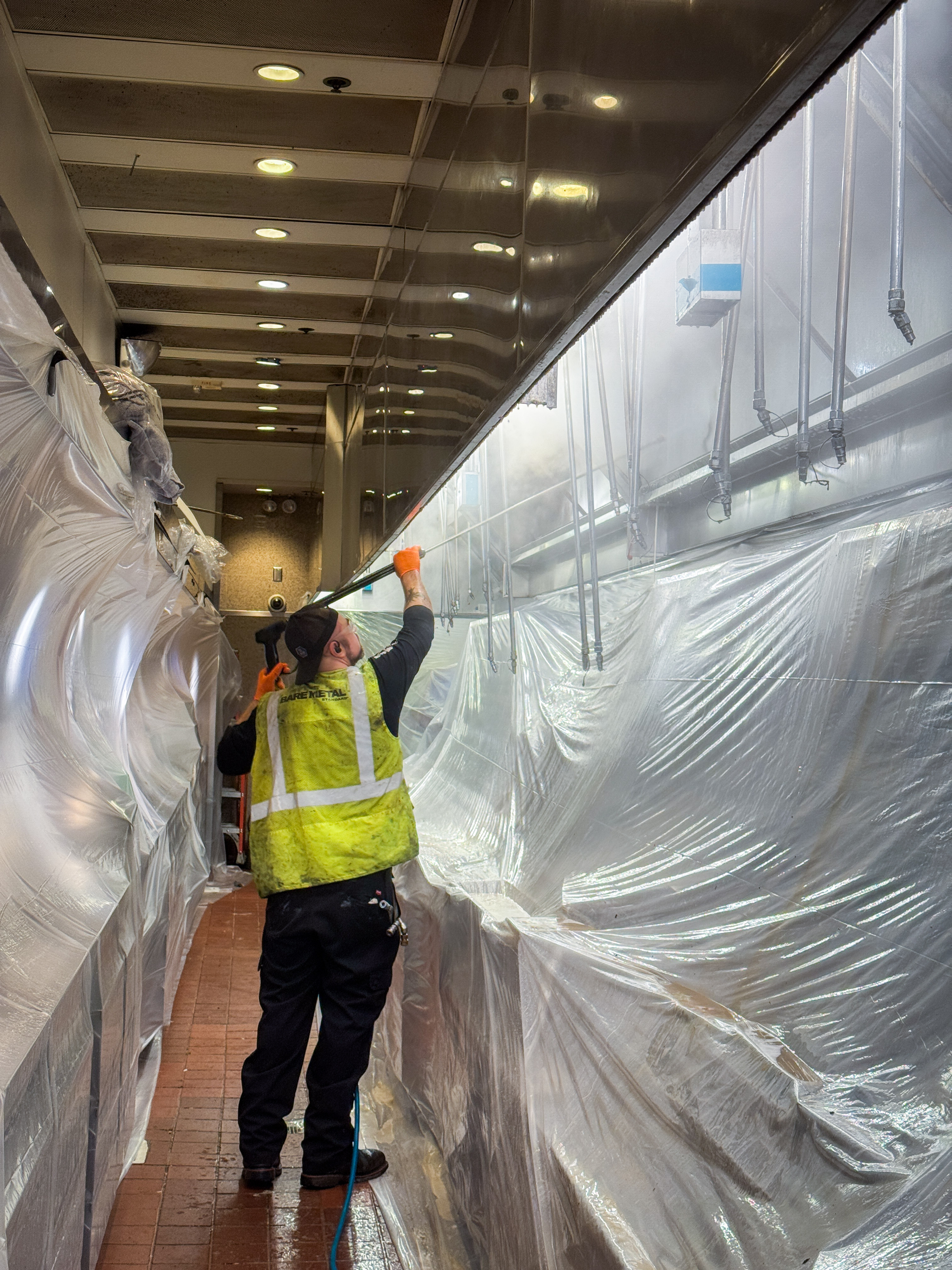 Technician providing commercial kitchen exhaust system fire safety service